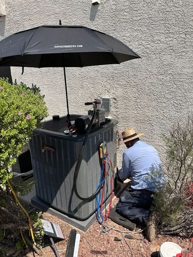 HVAC technician performing outdoor AC maintenance in Thornapple
